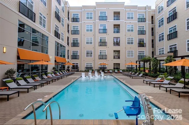 a view of a swimming pool with outdoor seating