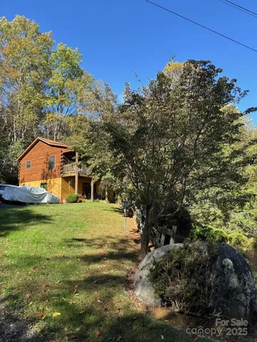 a view of a big yard with large trees