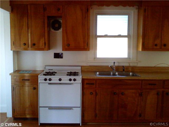 10002 White Oak Road Ford, VA 23850 - Photo 6 of 6 a kitchen with stainless steel appliances wooden cabinets stove and a window