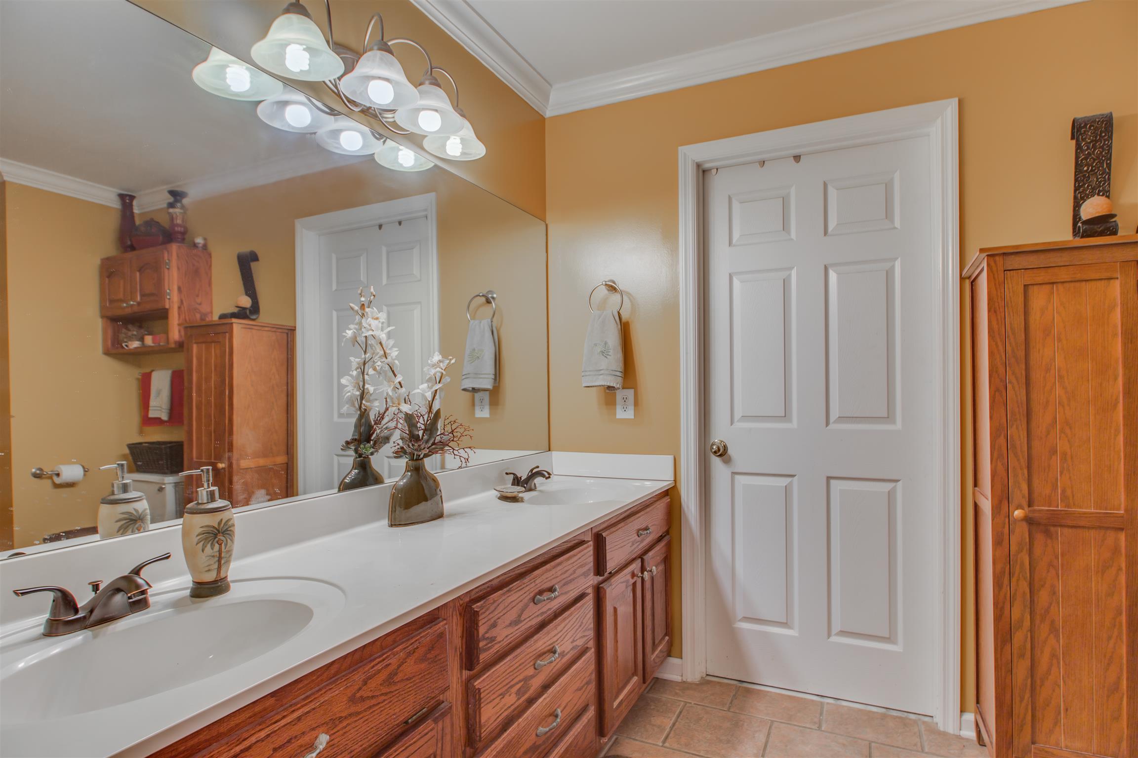 2943 Robert Skelley Road Columbia, TN 38401 - Photo 17 of 30 a bathroom with a double vanity sink and a mirror