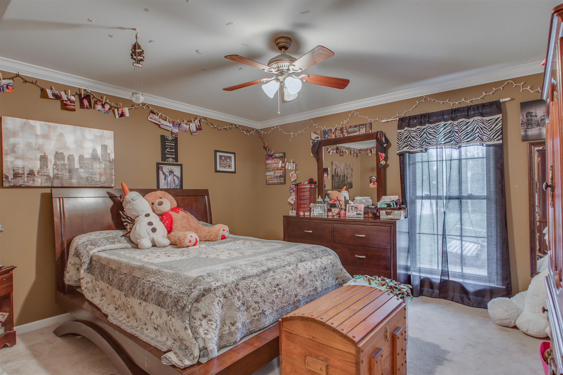 2943 Robert Skelley Road Columbia, TN 38401 - Photo 18 of 30 a bedroom with a large bed and a chandelier