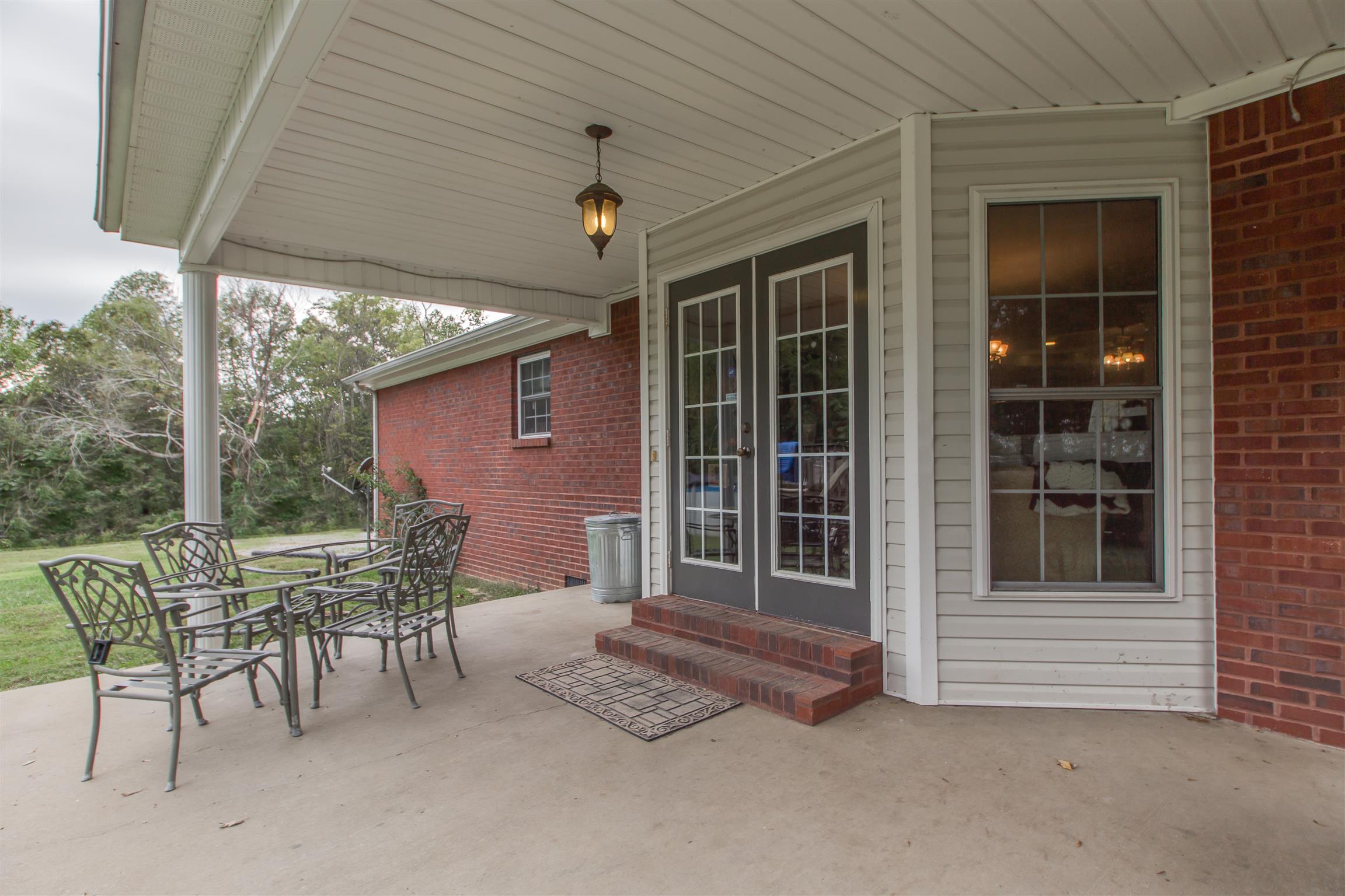 2943 Robert Skelley Road Columbia, TN 38401 - Photo 23 of 30 a patio with table and chairs and potted plants