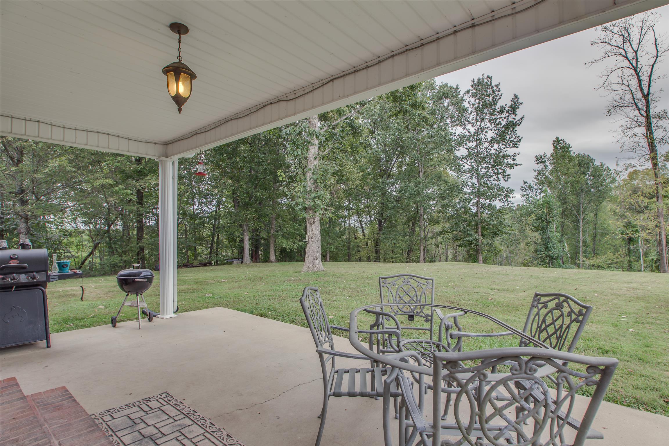 2943 Robert Skelley Road Columbia, TN 38401 - Photo 24 of 30 a view of a patio with a table chairs and a backyard