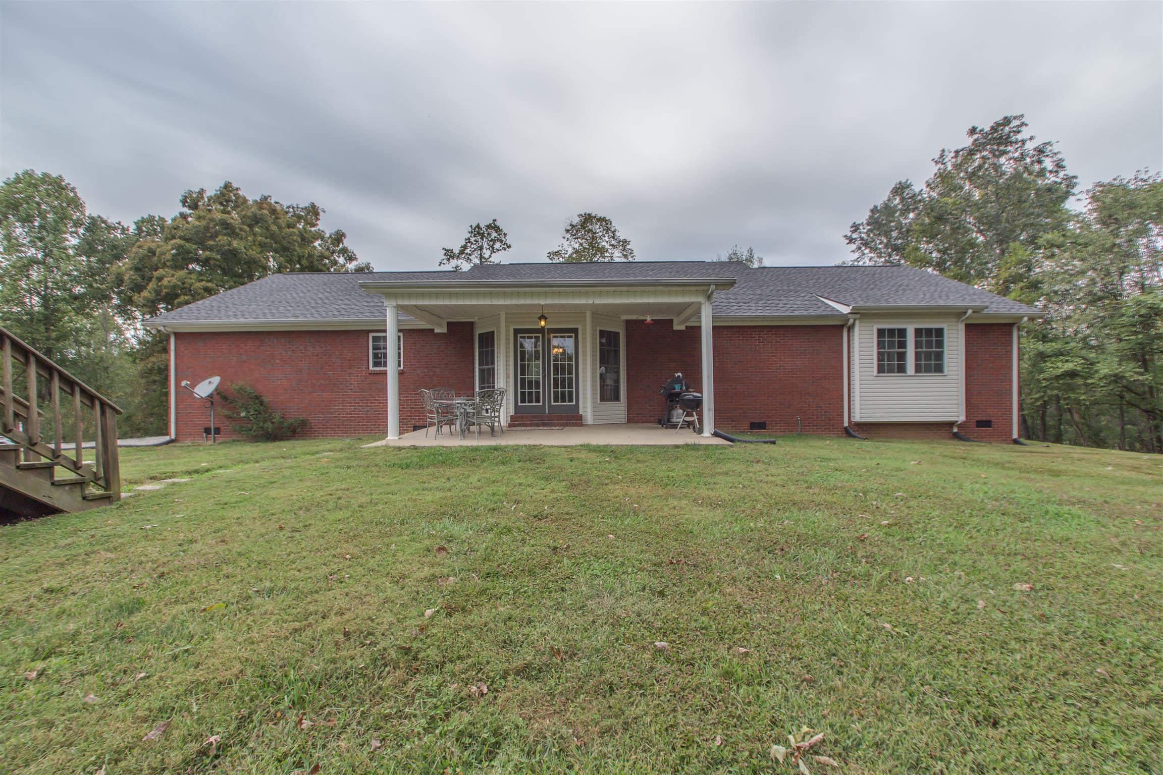 2943 Robert Skelley Road Columbia, TN 38401 - Photo 26 of 30 a front view of a house with a garden and yard