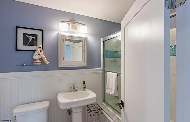 a bathroom with a sink a mirror and a toilet
