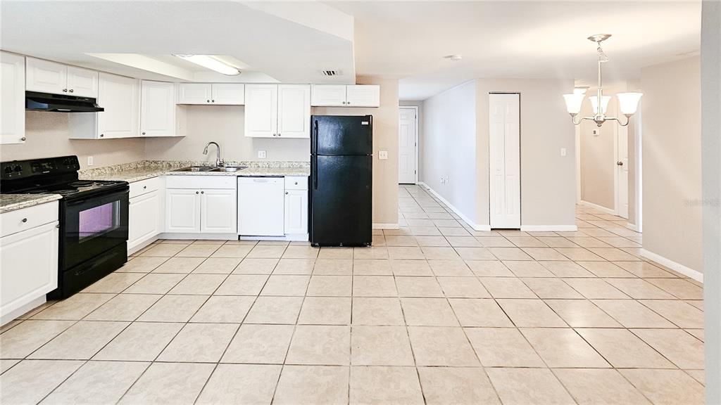 7304 Embassy Boulevard Port Richey, FL 34668 - Photo 6 of 14 a kitchen with a sink a stove and refrigerator