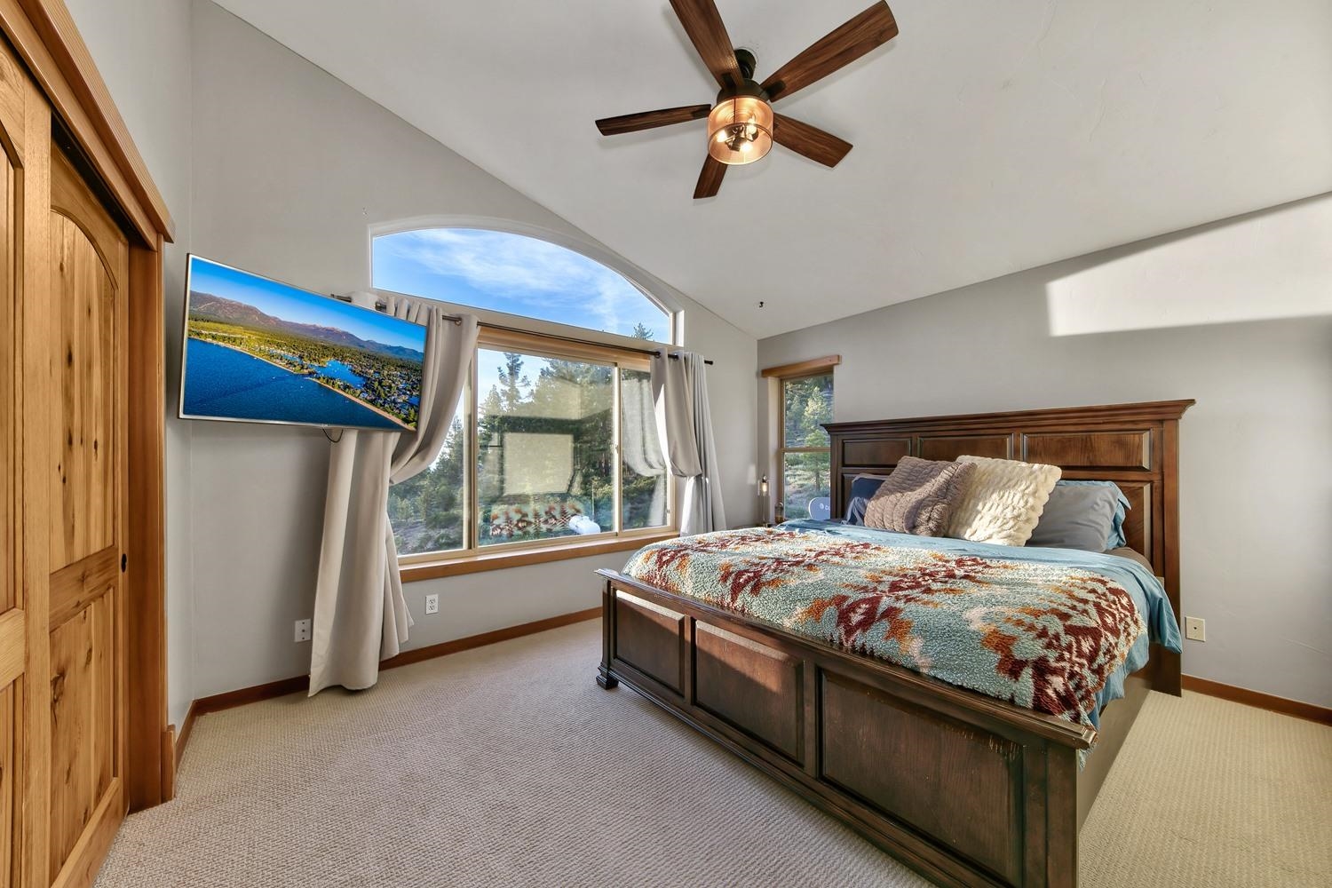 16125 Martis Peak Road Truckee, CA 96161 - Photo 18 of 21 a bedroom with a large bed and a chandelier fan