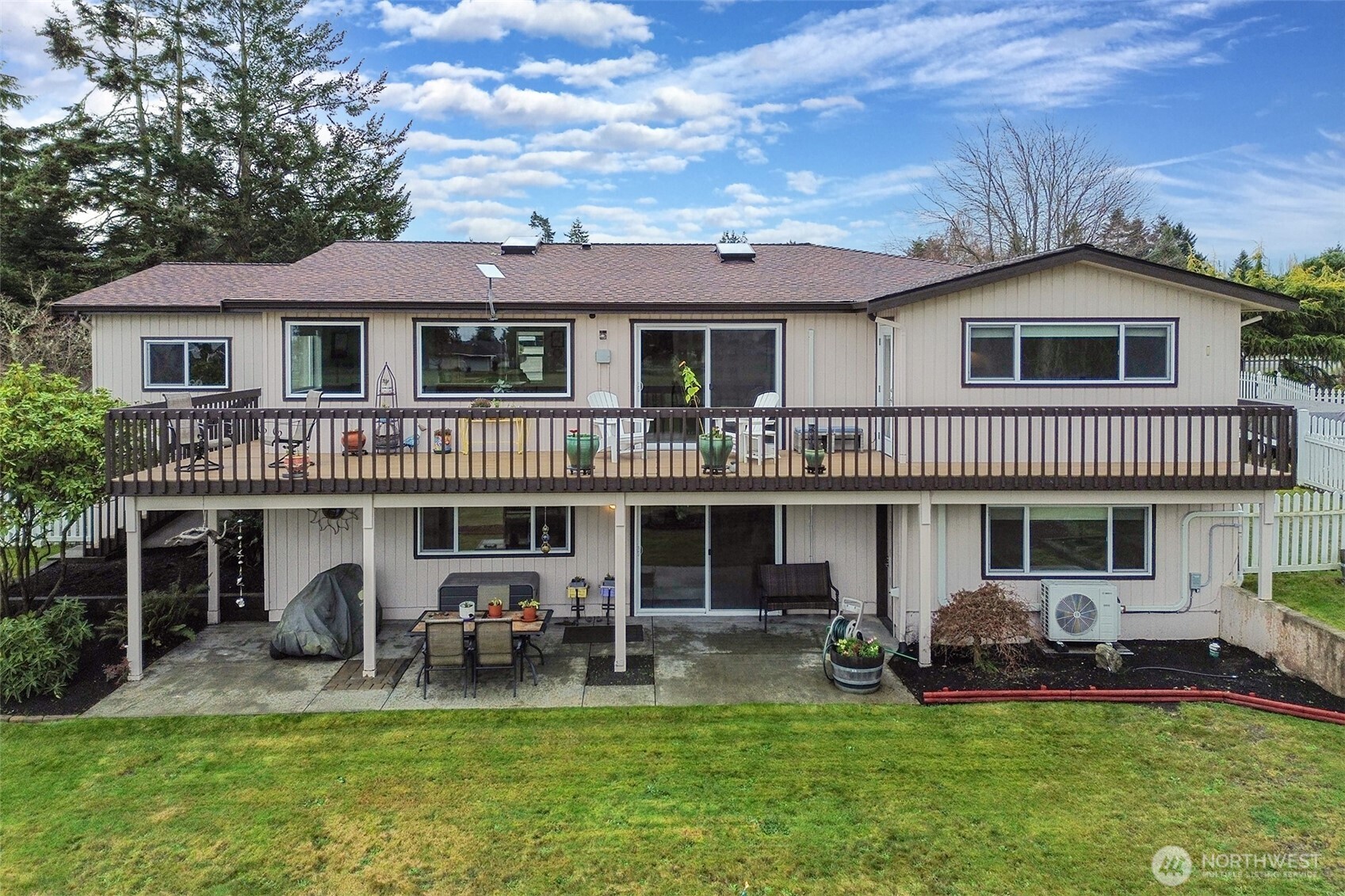 440 West Nelson Road Sequim, WA 98382 - Photo 2 of 39 a front view of a house with a yard table and chairs