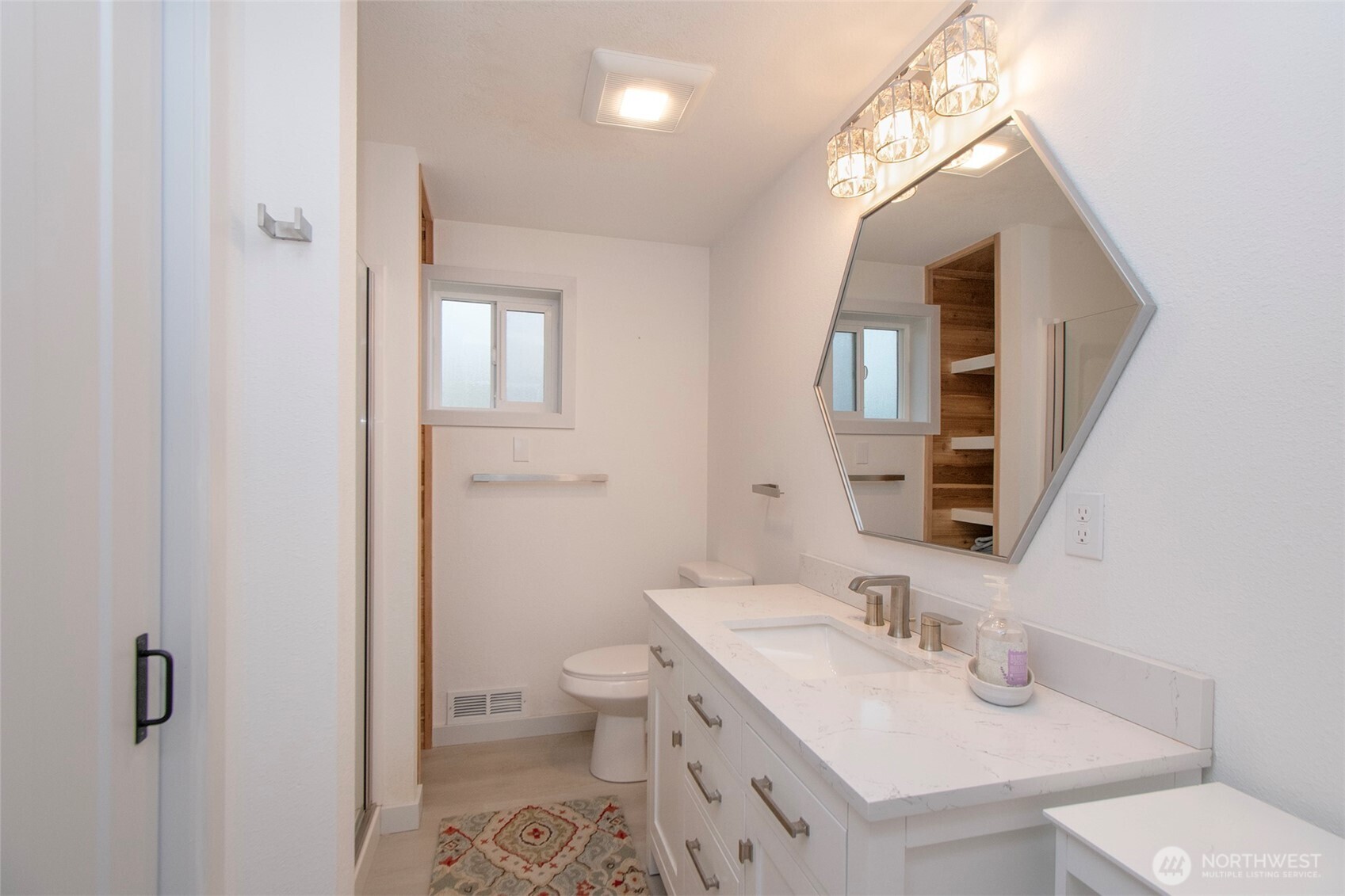 440 West Nelson Road Sequim, WA 98382 - Photo 22 of 39 a bathroom with a granite countertop sink mirror vanity and toilet