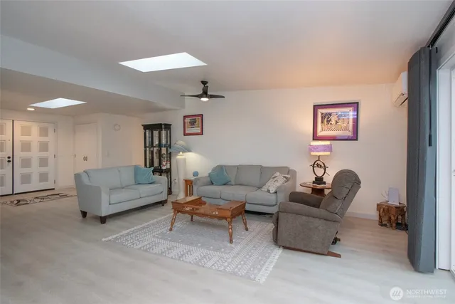 a living room with furniture and a painting