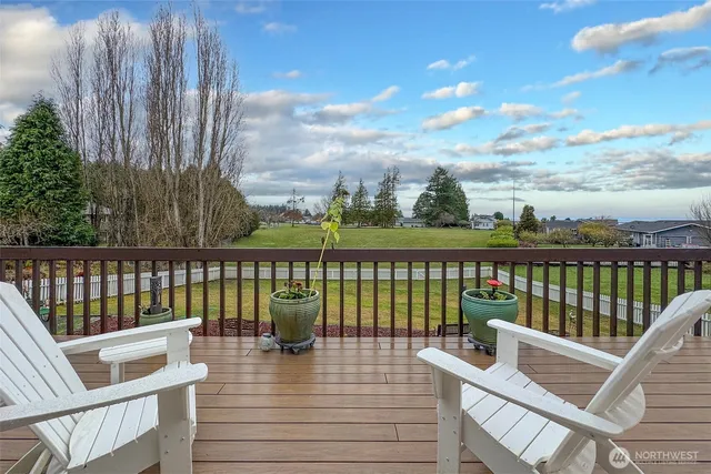 a view of a balcony with wooden floor & fence