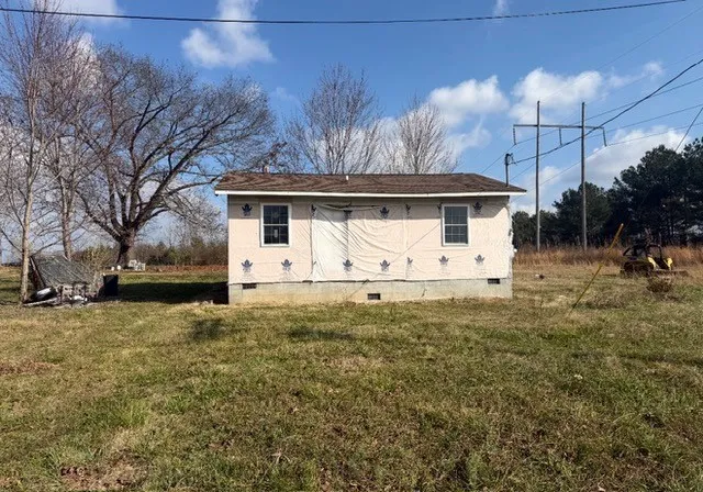 a front view of house with yard and trees