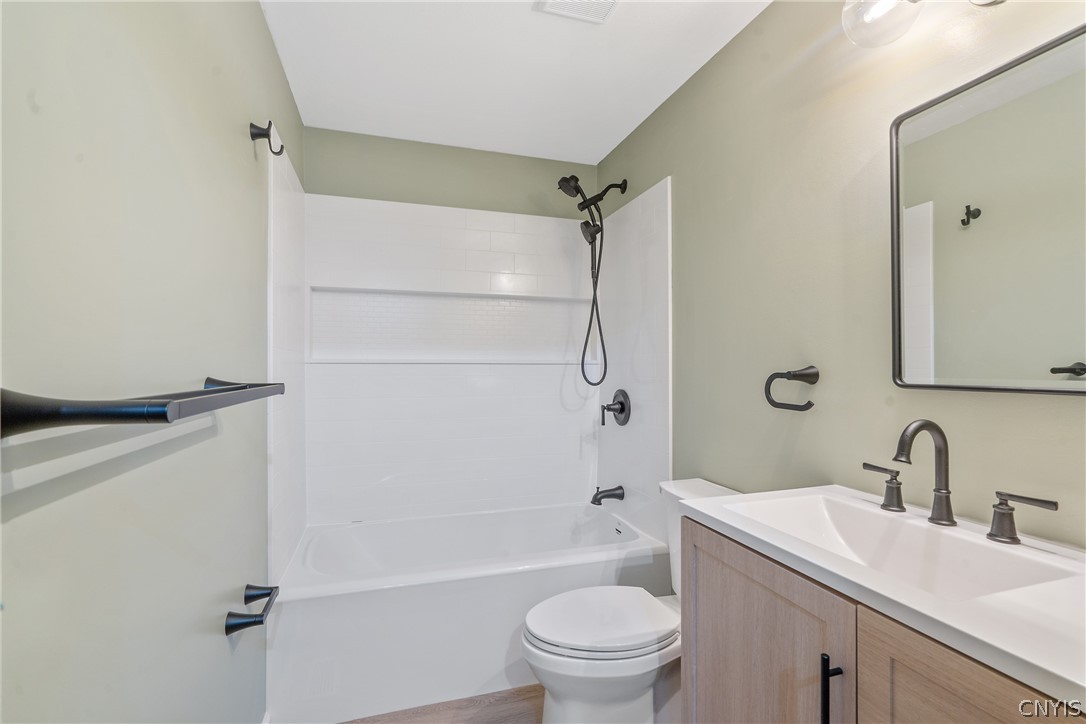 114 Saltwell Road Salina, NY 13090 - Photo 20 of 27 And yet another fully remodeled space! Everything in the full bathroom has been thoughtfully updated, including the LVP floor, shower/bath surround, toilet, vanity, lighting and accessories. All you need to do is bring a roll of TP & a bar of soap and you're in business!