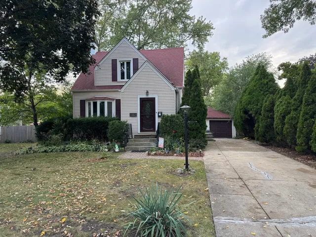 a view of a house with a yard and tree s