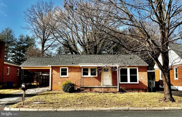 a front view of a house with a yard covered in snow