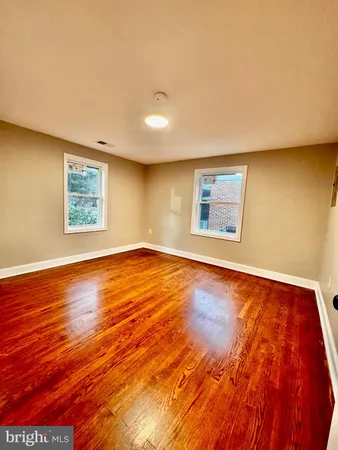 a view of a big room with wooden floor and window