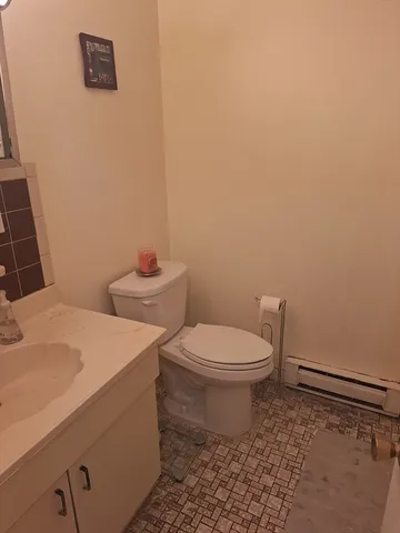 a white toilet sitting next to a white sink