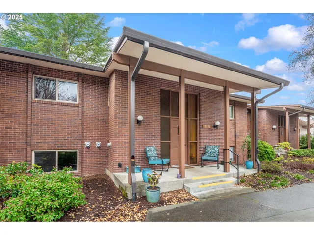 a view of a patio with table and chairs and potted plants