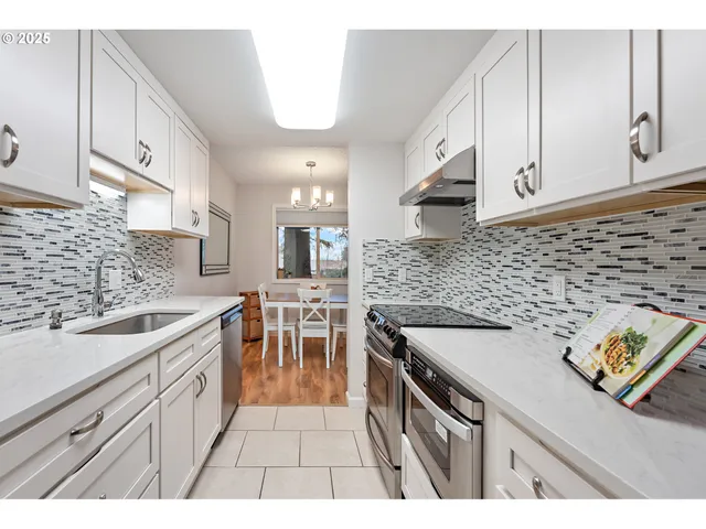 a kitchen with a sink stove and cabinets