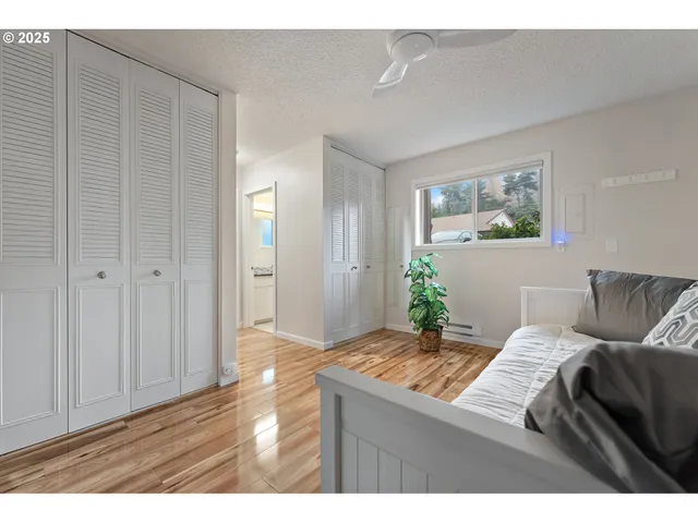 a bedroom with a bed and wooden floor