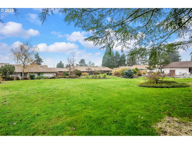 a view of an house with backyard space and garden