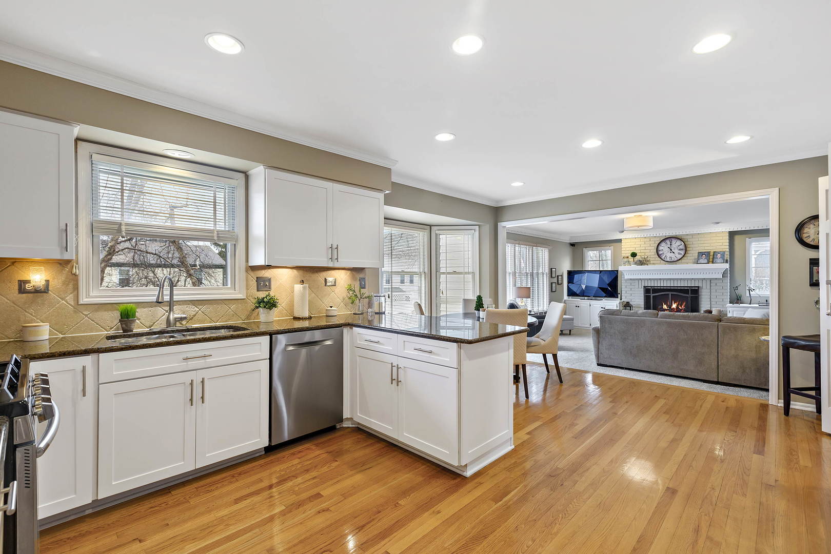 2706 Pebblebrook Lane Rolling Meadows, IL 60008 - Photo 11 of 34 a kitchen with stainless steel appliances granite countertop wooden floors and white cabinets