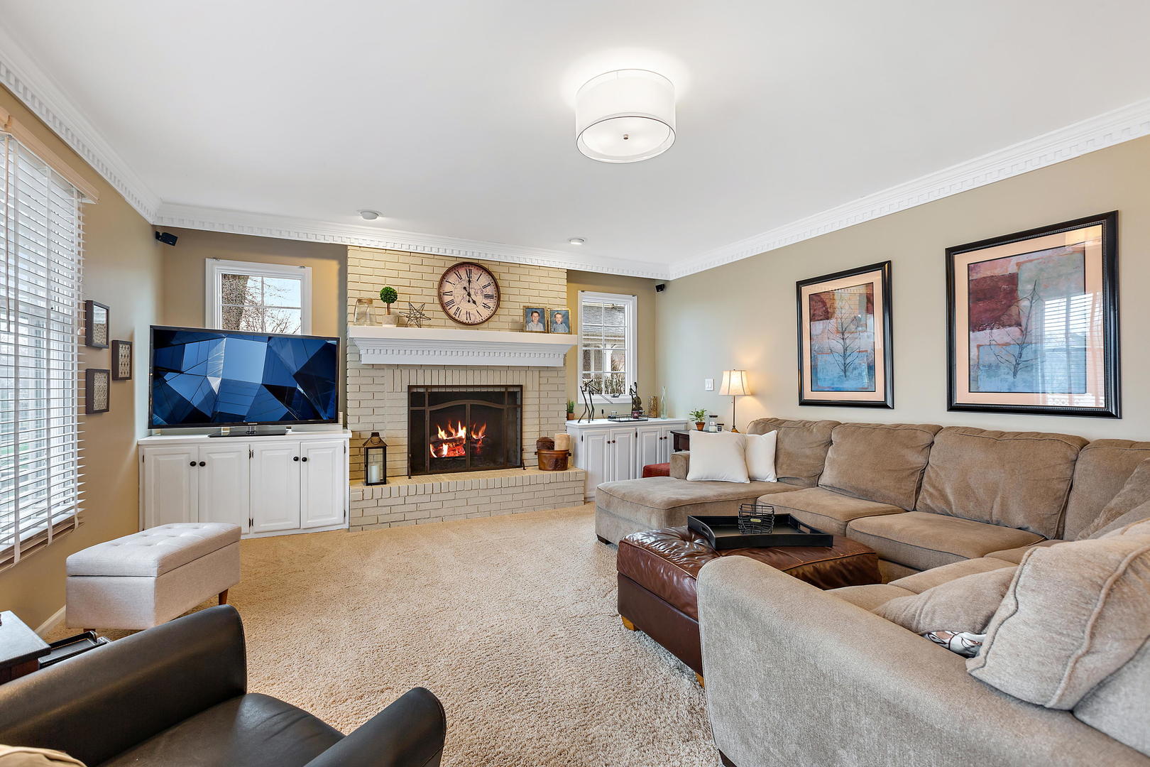 2706 Pebblebrook Lane Rolling Meadows, IL 60008 - Photo 13 of 34 a living room with furniture a flat screen tv and a fireplace