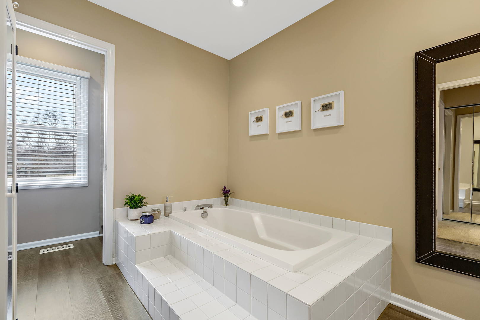 2706 Pebblebrook Lane Rolling Meadows, IL 60008 - Photo 18 of 34 a white bath tub sitting in a bathroom next to a window