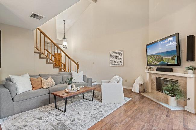 2101 Ornellas Drive Milpitas, CA 95035 - Photo 3 of 17 a living room with furniture a flat screen tv and a fireplace