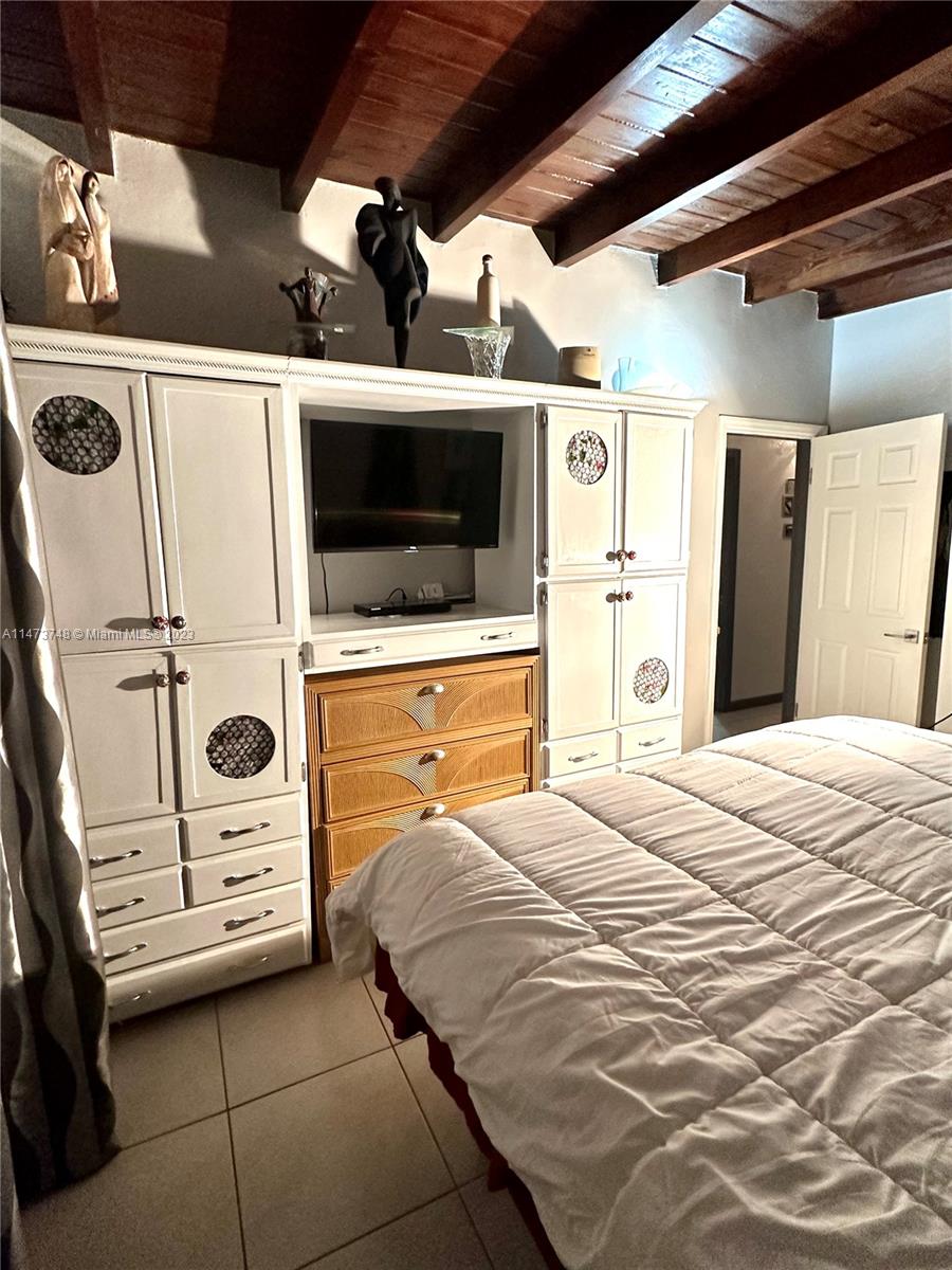 Olympia Heights Miami, FL 33165 - Photo 16 of 45 a bedroom with a bed a flat screen tv and dresser