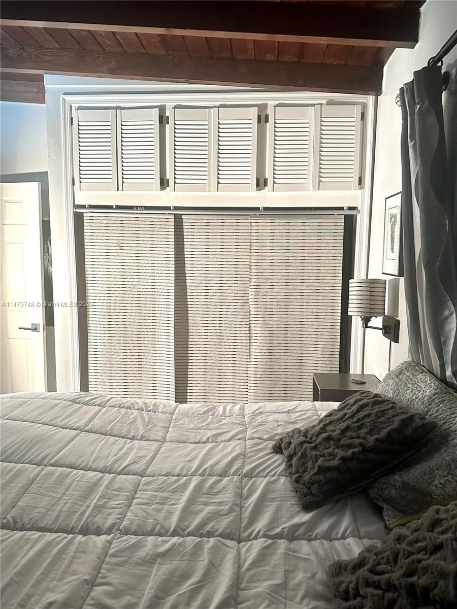 Olympia Heights Miami, FL 33165 - Photo 17 of 45 a bedroom with a bed tv and a window