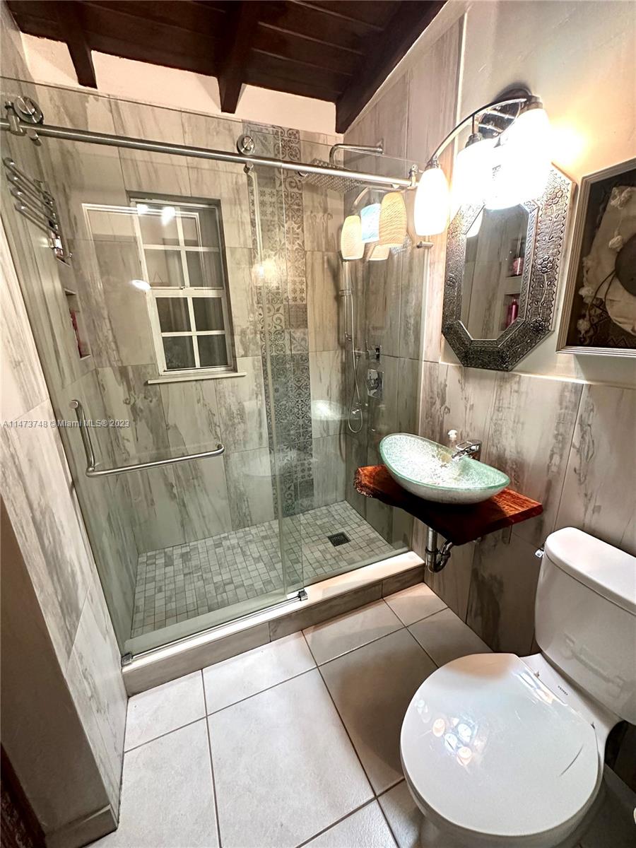 Olympia Heights Miami, FL 33165 - Photo 25 of 45 a bathroom with a toilet and a sink