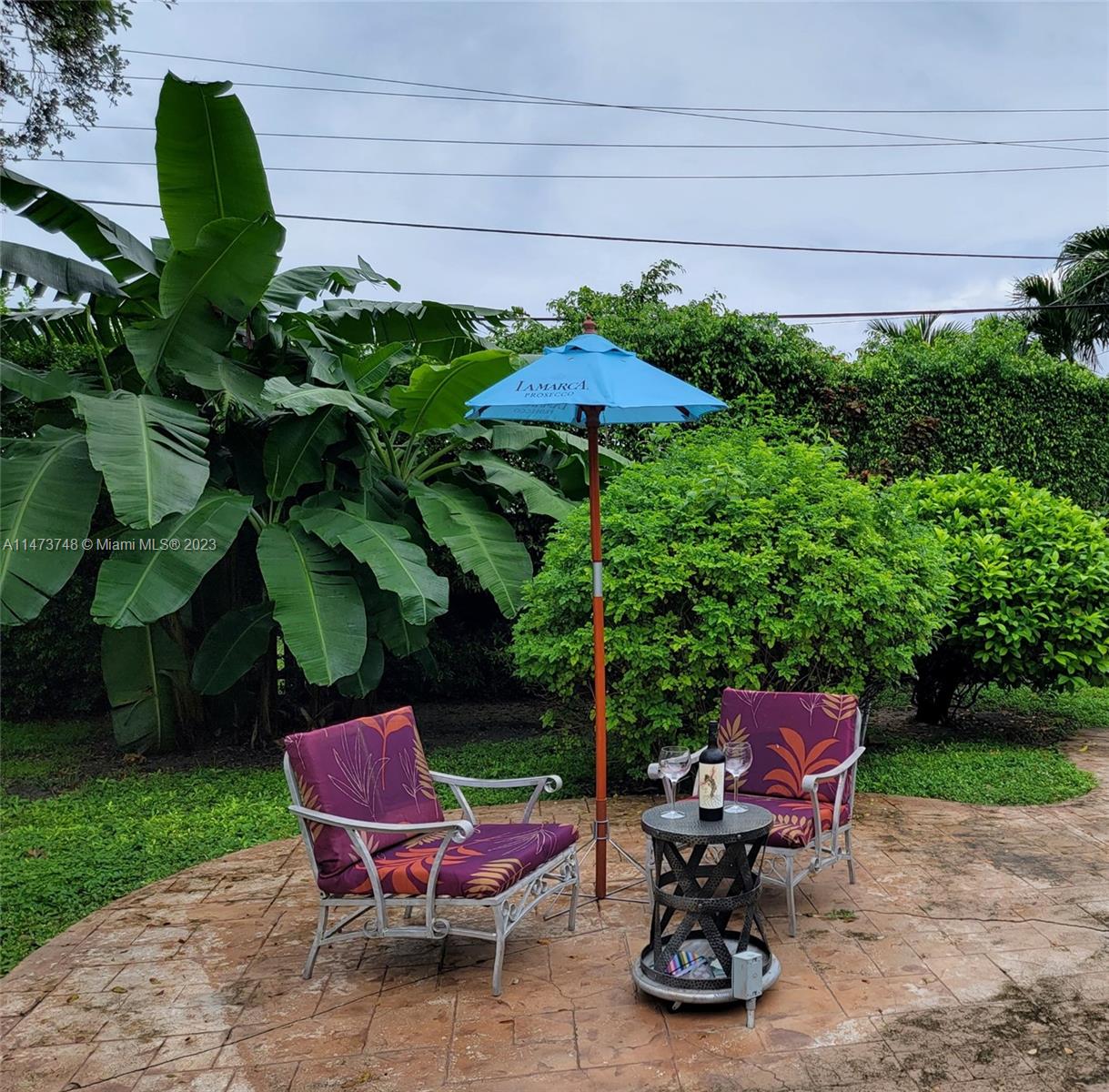 Olympia Heights Miami, FL 33165 - Photo 32 of 45 a view of a chairs and table in backyard of the house
