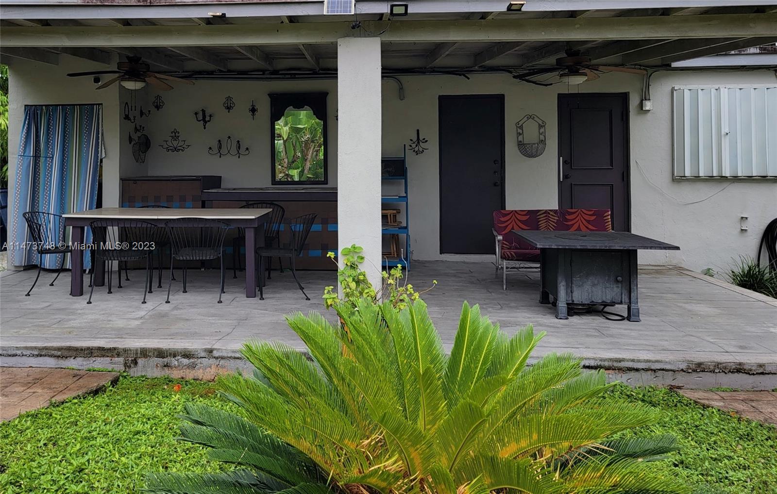 Olympia Heights Miami, FL 33165 - Photo 35 of 45 a backyard of a house with outdoor seating
