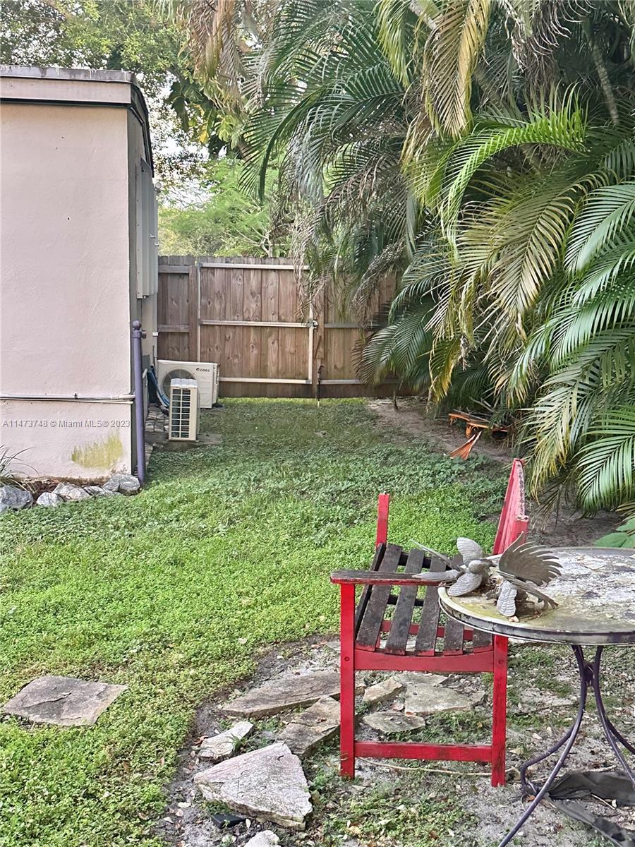 Olympia Heights Miami, FL 33165 - Photo 40 of 45 a view of a backyard with table and chairs and potted plants