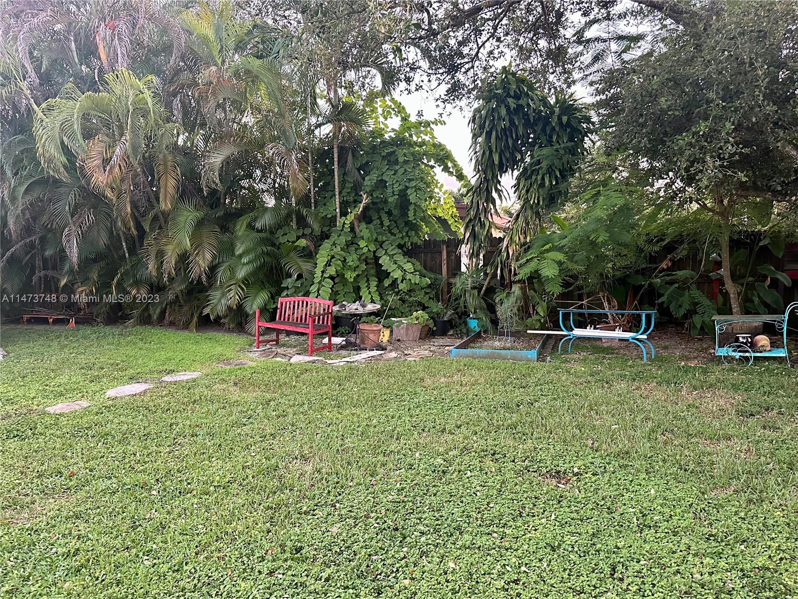 Olympia Heights Miami, FL 33165 - Photo 43 of 45 a backyard of a house with table and chairs