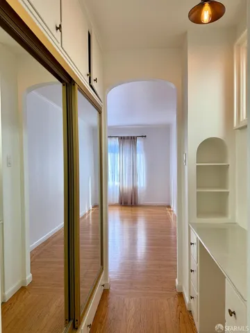 a view of hallway with stairs and wooden floor