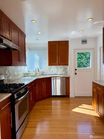 a kitchen with granite countertop a stove and cabinets