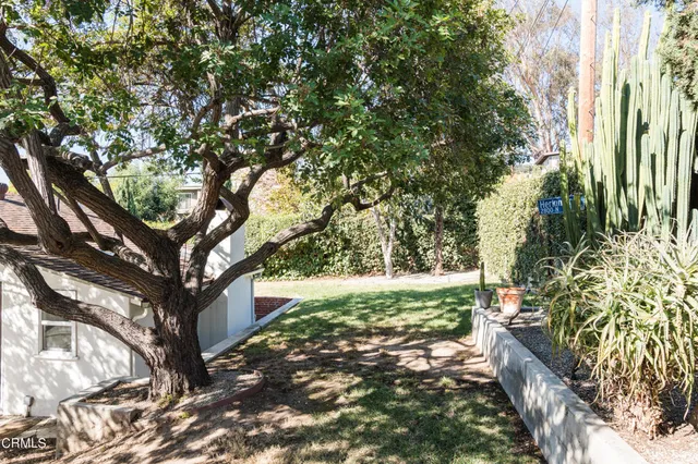 a backyard of a house with a yard and outdoor seating