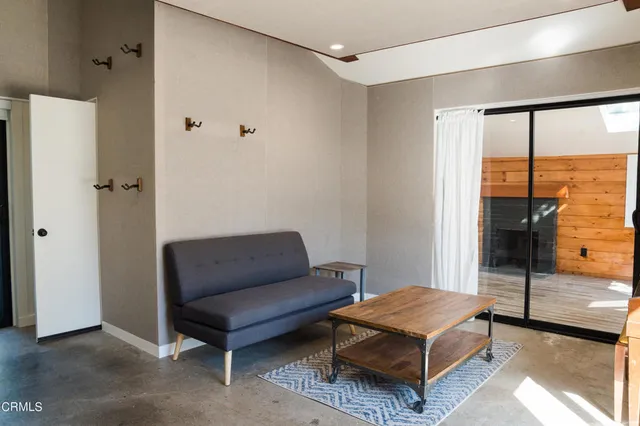 a living room with furniture and a floor to ceiling window