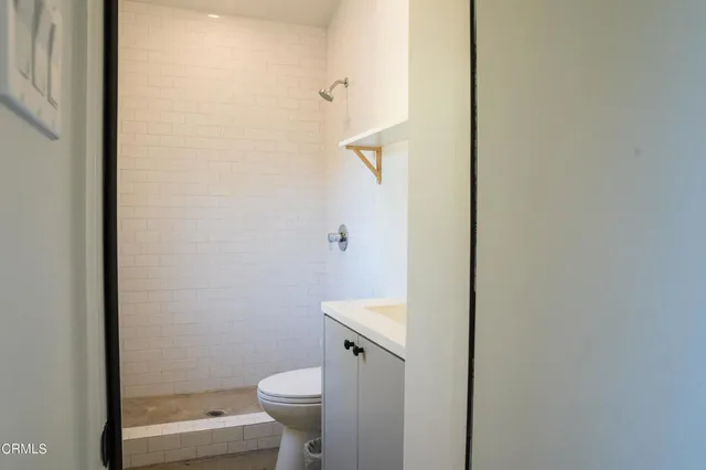 a bathroom with a toilet a sink and a shower