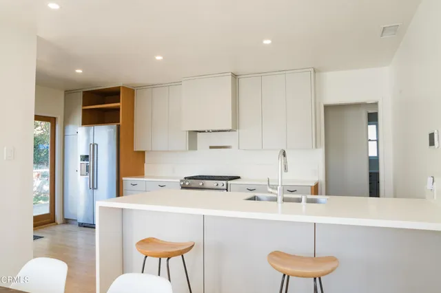 a kitchen with stainless steel appliances a sink and a refrigerator