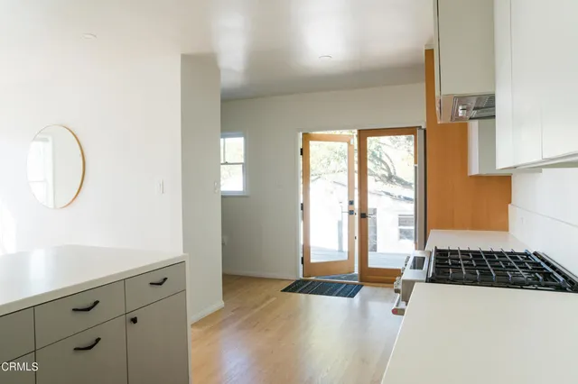 a spacious bathroom with a tub sink and a mirror