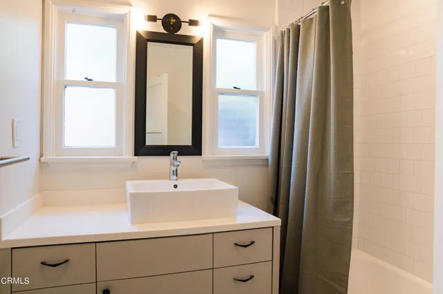 a bathroom with a sink a vanity and a mirror
