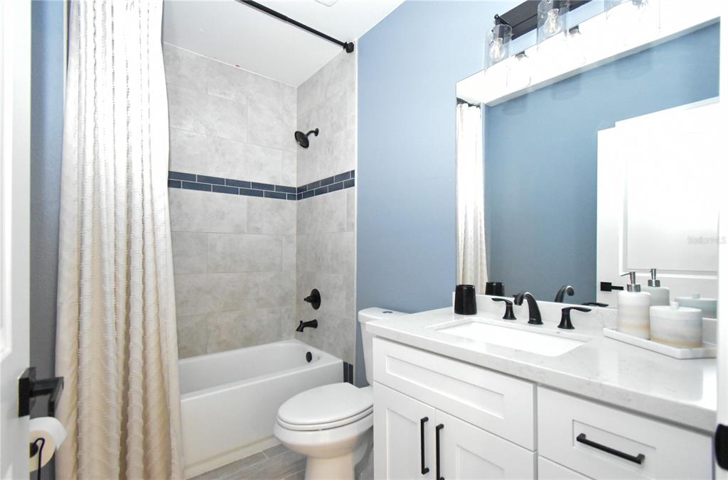 7890 Southwest 129th Avenue Cedar Key, FL 32625 - Photo 29 of 45 a bathroom with a granite countertop sink toilet and shower
