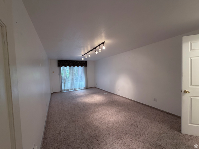 2855 South 1000 West Perry, UT 84302 - Photo 135 of 142 Empty room featuring track lighting and carpet