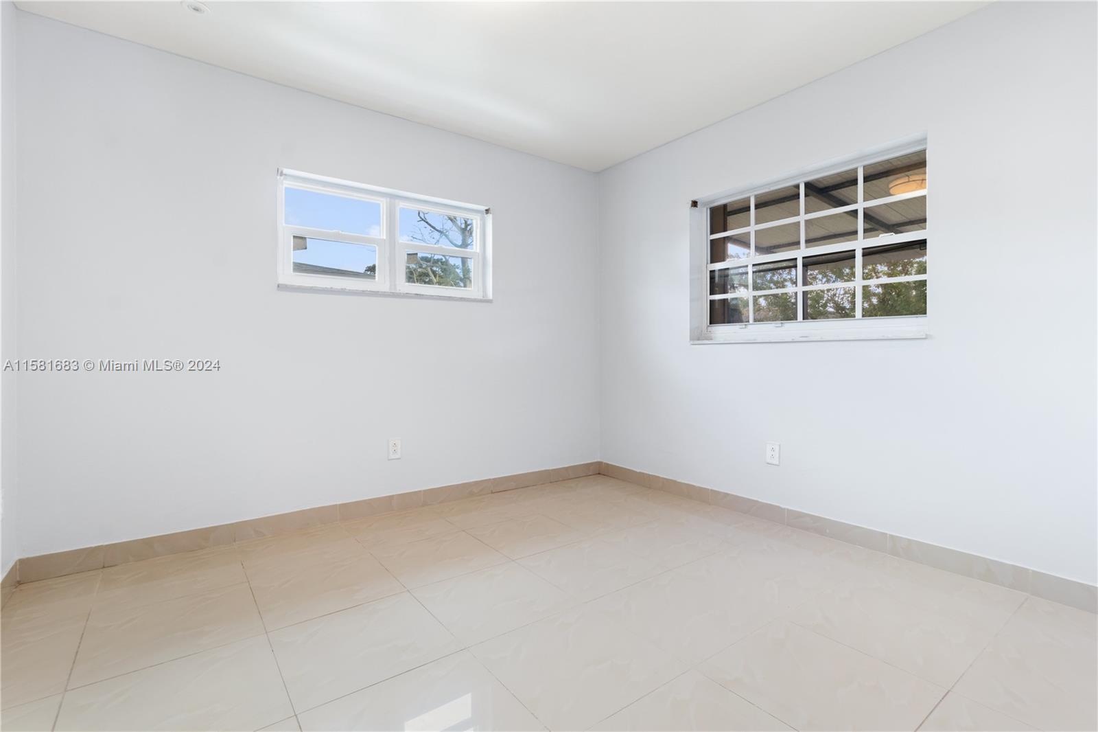 10680 Ember Street Boca Raton, FL 33428 - Photo 13 of 19 an empty room with windows