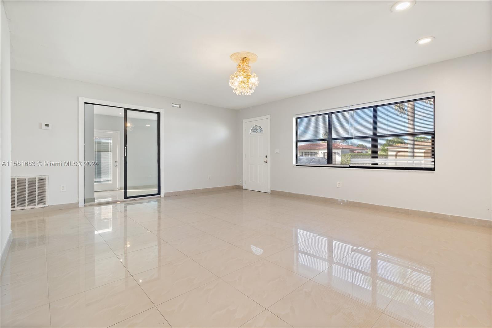 10680 Ember Street Boca Raton, FL 33428 - Photo 4 of 19 wooden floor in an empty room with a window