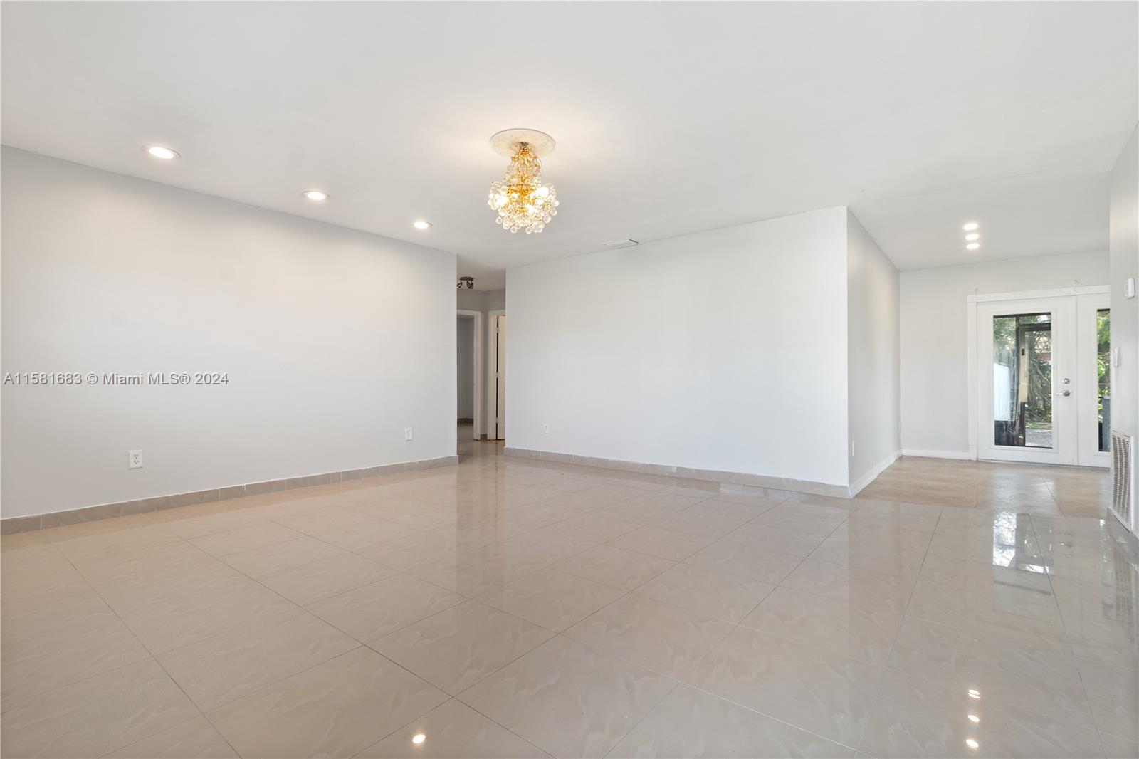 10680 Ember Street Boca Raton, FL 33428 - Photo 5 of 19 an empty room with wooden cabinet and windows