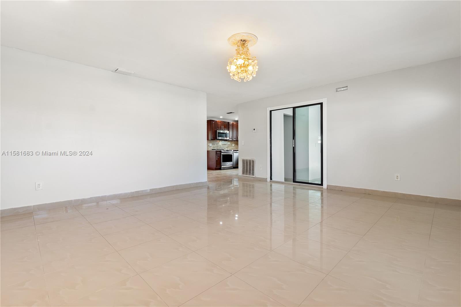 10680 Ember Street Boca Raton, FL 33428 - Photo 7 of 19 a view of an empty room with a window